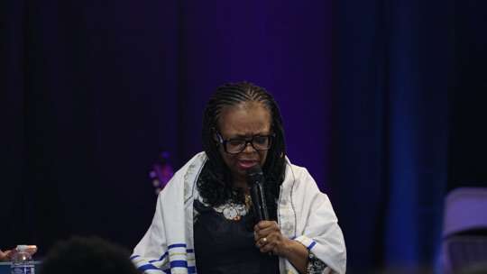Congregation in worship under string lights
