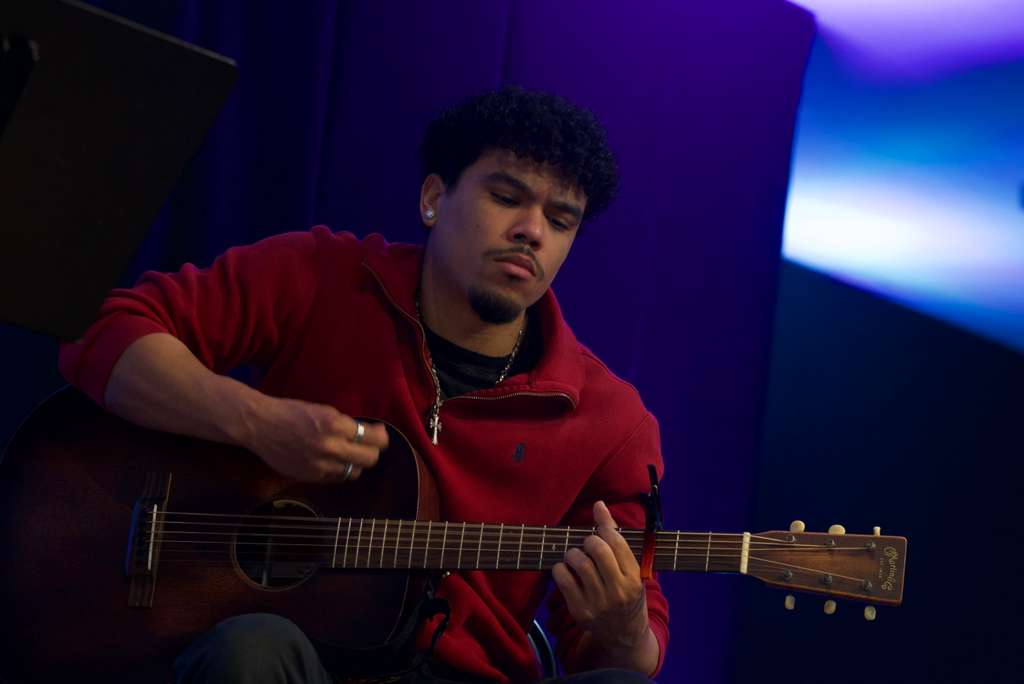 Worship leader on acoustic guitar